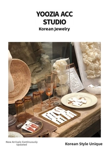 Artistic display of assorted vintage style earrings on decorative ceramic and metal trays
