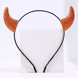 Detailed view of sparkly orange glitter devil horn headband for Halloween parties