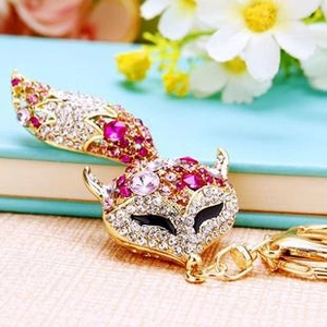 Detail of fox-shaped keychain with pink rhinestones and gold-plated metal finish