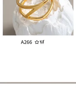 Detailed macro shot of a gold minimalist double-layer geometric ring on a textured fabric