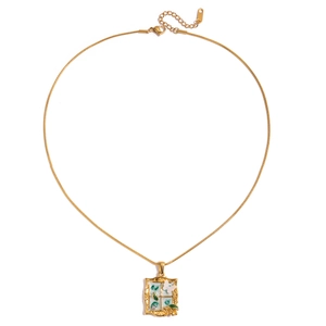 Vintage gold snake chain necklace with green window and butterfly pendant on white background