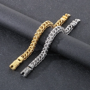 Close-up of retro wheat chain bracelets in gold and silver with embossed clasp details