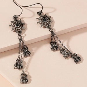 Macro view of Halloween spider earrings with black gemstone and cascading chains