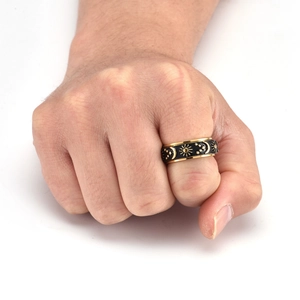 Detail of vintage sun moon star spinning ring with gold trim and black enamel design