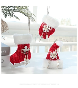 Detailed view of red knitted Christmas glove, skate, and hat ornaments with white fur trim