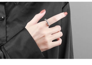 Close-up of a silver beaded spinner ring on a finger for anxiety relief and focus