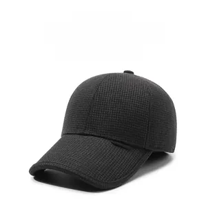 Close-up of black baseball cap with thick textured fabric and brand label for winter