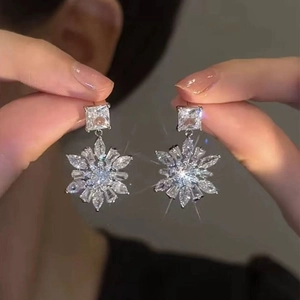 Elegant sparkling snowflake tassel drop earrings with square cut diamonds and silver finish