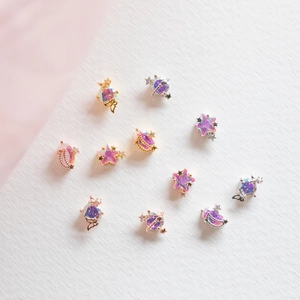 Detail of 18K gold plated celestial earrings featuring stars, moon and cat with opal stones