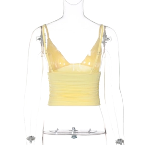 Detailed back view of yellow cropped camisole with thin straps and ruched waist detail
