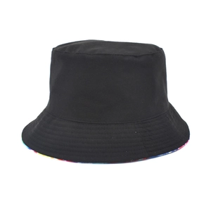Minimalist black tie-dye bucket hat with reversible design and colorful rainbow brim lining