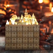 Macro detail of LED wooden advent calendar featuring carved village scene and 24 drawers