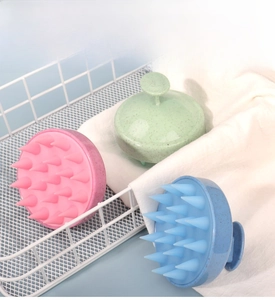 Three-color silicone scalp massager brushes in pink, mint green and blue in a basket