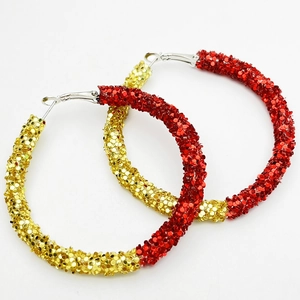 Detailed view of red and gold glitter hoop earrings featuring a shiny sequin finish