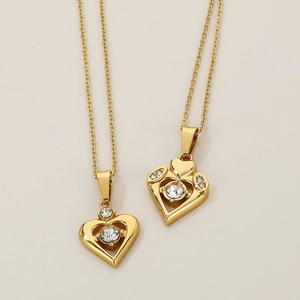 Macro detail of gold layered heart necklace pendant with sparkling crystal inlay