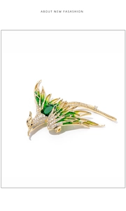 Detail of phoenix brooch with green enamel wings and sparkling cubic zirconia stones