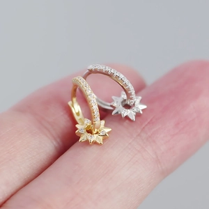 Close-up of luxury gold and silver star earrings with micro-pave cubic zirconia