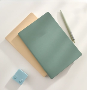Close-up of A6 notebooks with textured faux leather covers and gold stamped NOTES text