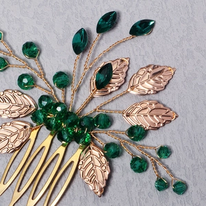 Macro shot of golden leaf hair comb with green faceted beads and detailed branch design