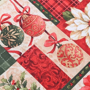 Close-up of festive Christmas table runner featuring red poinsettia and plaid pattern