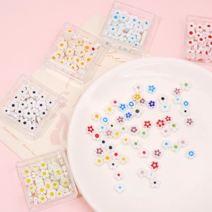 Mini colorful millefiori flower beads in a white plate for DIY jewelry making