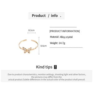 Detailed view of golden butterfly arm cuff with dimensions 8.1cm by 8.6cm and weight 14.7g