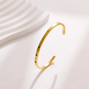 Detail of 18k gold plated stainless steel C-shaped cuff with five colorful zircon stones
