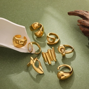Artistic close-up of chunky gold geometric rings with 18K gold plating and organic shapes