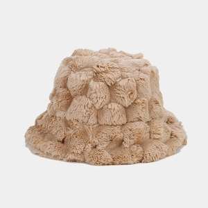 Close-up of beige faux fur bucket hat featuring a tactile pineapple texture pattern