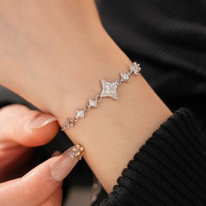 Close-up of star-shaped bracelet with pave zircon inlay worn on a female wrist