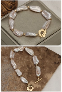 Macro detail of baroque pearls with golden flower OT clasp and iridescent luster