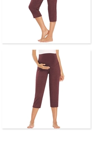 Detail of high waist maternity leggings in wine red featuring elastic belly support