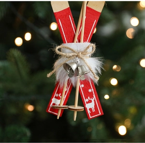 Macro shot of red wooden Christmas sled ornament with metal bell and plush details
