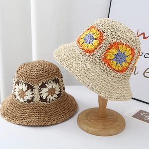 Handwoven straw bucket hat for women with colorful floral patterns in beige and brown