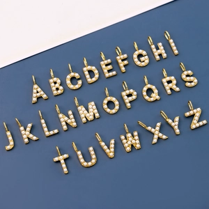 Detailed set of 26 alphabet charms with gold plating and small pearls for DIY jewelry