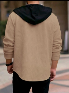Detailed back view of men's khaki hoodie with geometric jacquard fabric and black hood
