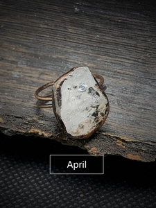Detailed close-up of April birthstone raw crystal ring with vintage bronze band