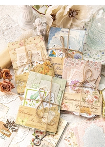 Close-up of Flower Post Office Series vintage stickers on lace with props
