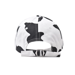 Detail of cotton baseball cap with cow print and adjustable metal back buckle closure