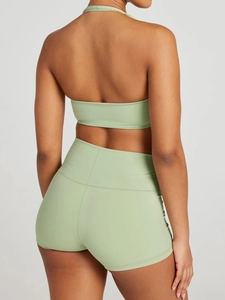 Back view of light green athletic set showing halter crop top and high waist shorts