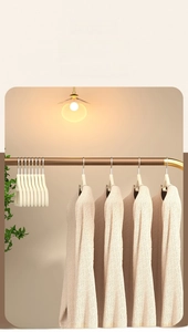 Detail of beige flocked hanger with non-slip texture for preventing shoulder bumps on clothes