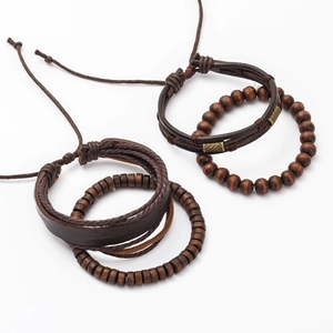 Detail of men's multilayer brown leather and wood bead bracelets with brass accents