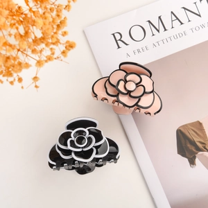 Elegant acetate camellia hair claw clips in black and pink for French twist hairstyles
