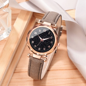 Detail of starry blue dial and faceted crystal on a rose gold women's watch