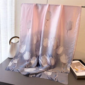 Close-up of lightweight silk-like scarf featuring pink gradient and white tulip floral print