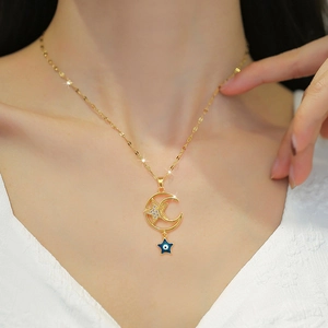 Luxury gold titanium steel necklace featuring moon star and blue eye charms on a model