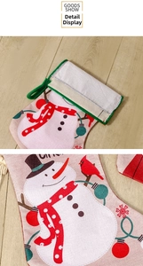 Detail showing linen Christmas stocking with snowman, red bird print and green velvet loop