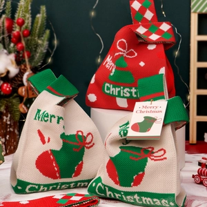 Christmas knitted gift bags in red and off-white featuring festive trees and socks