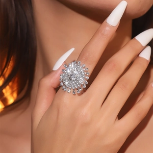 Macro shot of a brilliant crystal flower ring in silver finish worn by a model