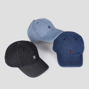 Detailed view of three denim baseball caps with R letter embroidery in various washes